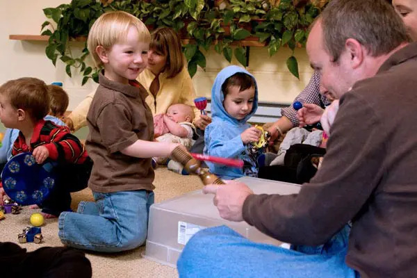 children and caregiver in music together class