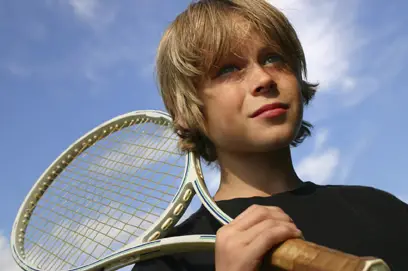 nervous boy with tennis racquet