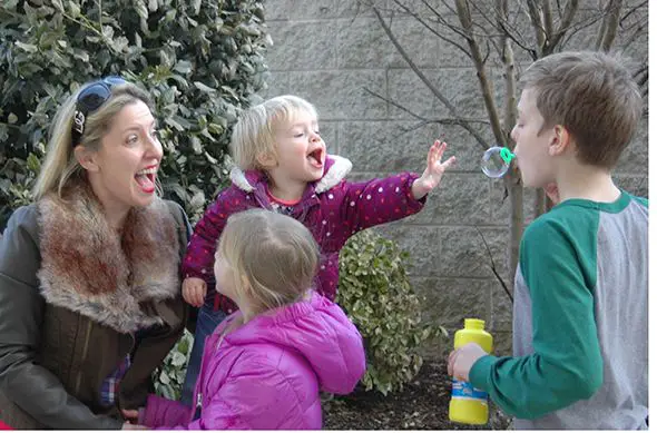 mom and kids blowing bubbles