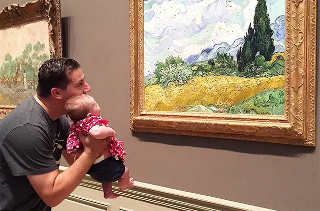 dad and baby looking at art