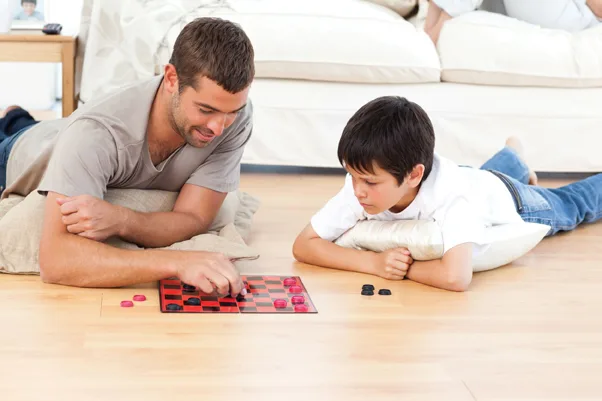 older man and young boy playing checkers