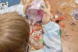 child painting; little boy finger painting; making a mess with paint