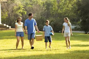 family picnicking in a park; family picnic; summer