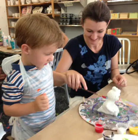 owner and son paint pottery