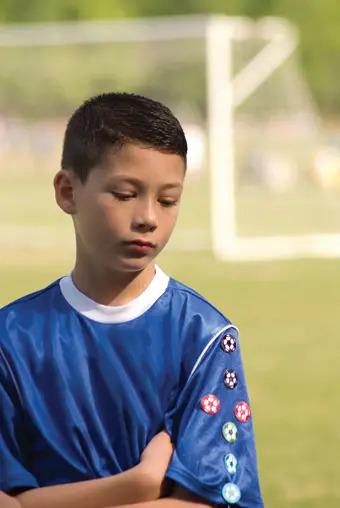 sad boy on soccer field