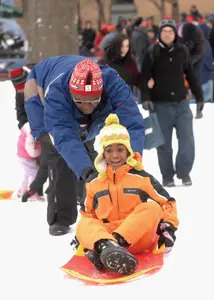 sledding in brooklyn; father and son sledding