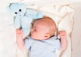 sleeping baby with teddy bear