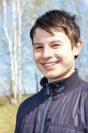 teen boy smiling outside