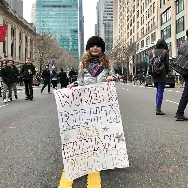 girl holding protest sign