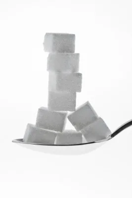 Sugar cubes stacked on spoon