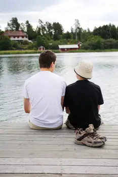 boy and camp counselor sitting by the lake at summer camp; camp pemigewasset