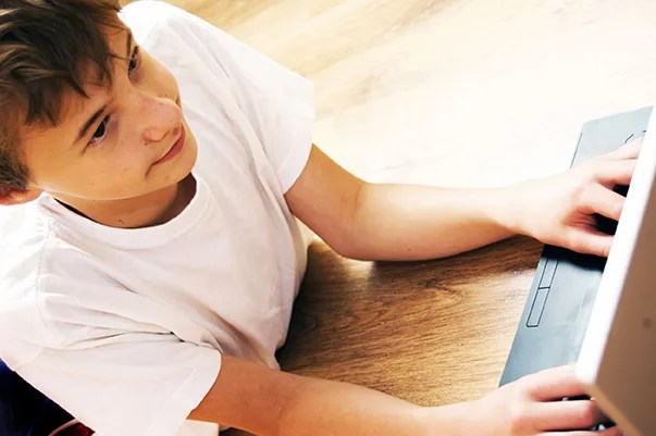 teen boy on computer