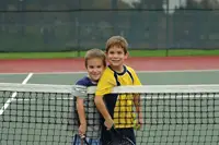 free tennis lessons in Manhattan; two boys playing tennis