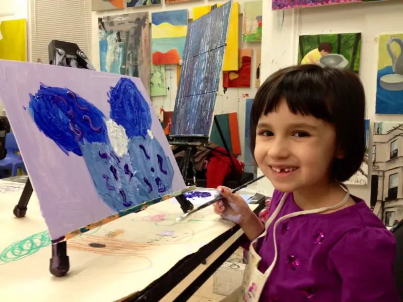 young girl painting a picture