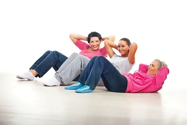 three women doing sit-ups