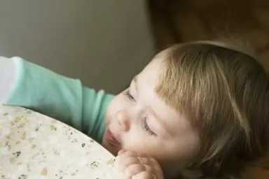 toddler-reaching-up-on-dresser
