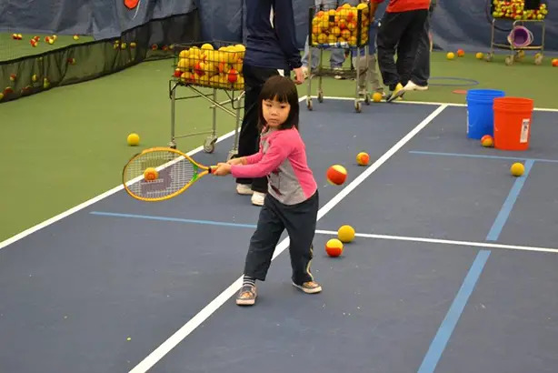 young girl playing tennis