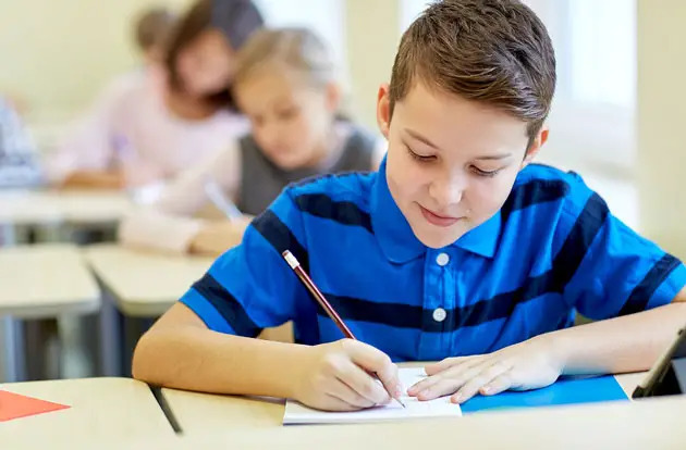 young boy writing