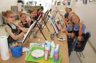young-children-painting-inside-art-studio-with-easels
