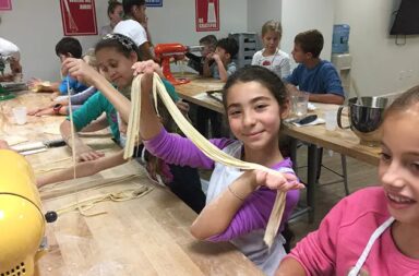 young-girl-making-pasta-in-classroom