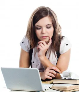 Girl with computer and books studying