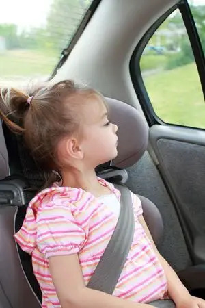 young girl in a booster seat