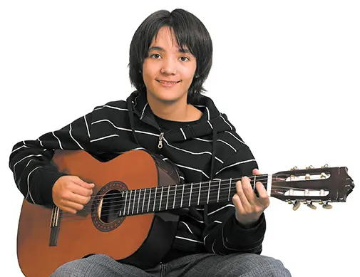 teen boy playing guitar