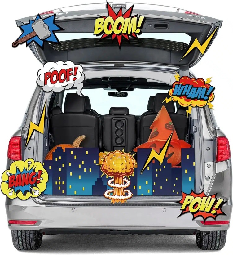 Silver minivan trunk decorated with comic-style superhero cityscape, explosion graphics, and bold “BOOM,” “POOF,” “BANG,” “WHAM,” and “POW” signs.
