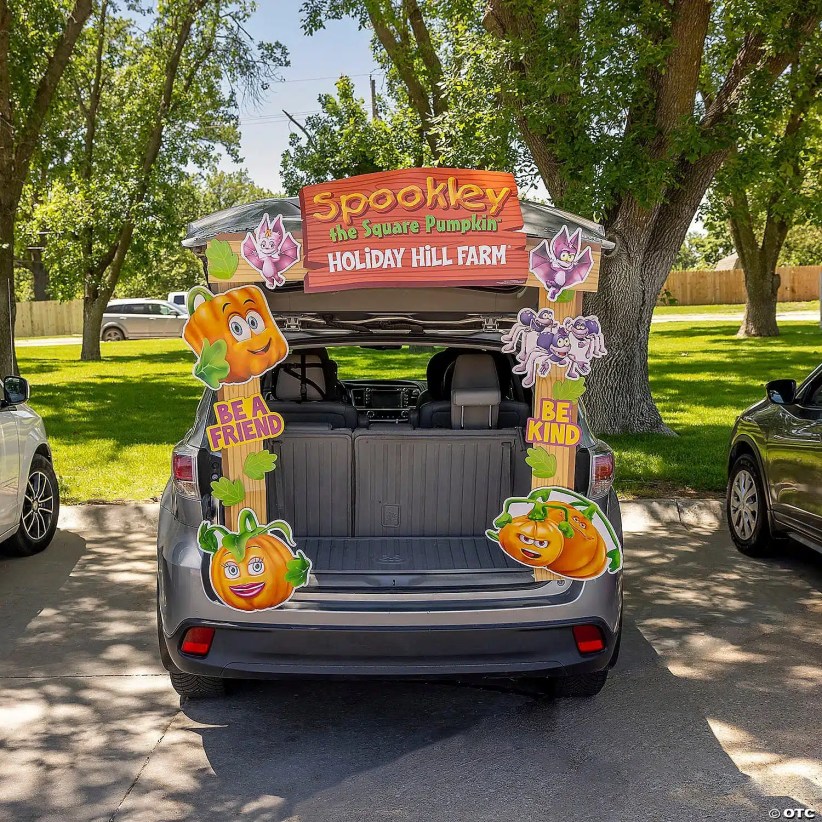 SUV trunk decorated with Spookley the Square Pumpkin characters, colorful “Be a Friend” and “Be Kind” signs, and Holiday Hill Farm banner