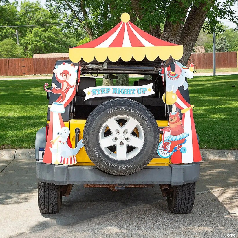 Jeep trunk decorated as a circus tent with “Step Right Up” sign, playful clown animals, and bright red-and-yellow carnival canopy.