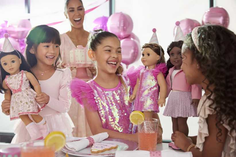 Girls at American Girl celebrating Birthday with American Girl dolls.