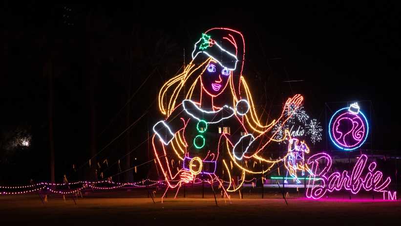 LED lights form a Barbie Doll image wearing a Santa hat and Santa inspired outfit.