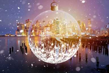 New York City skyline evening snow view through glass christmas ball, famous skyline