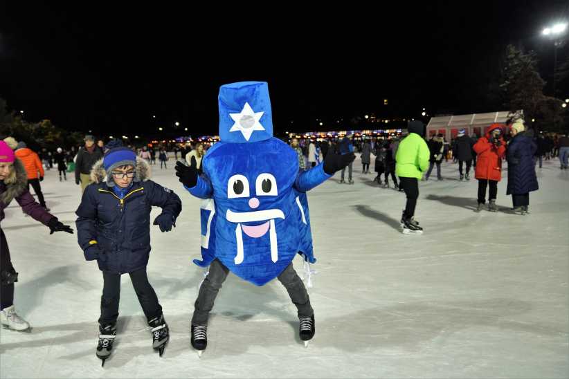 Blue Dreidel mascot ice skating