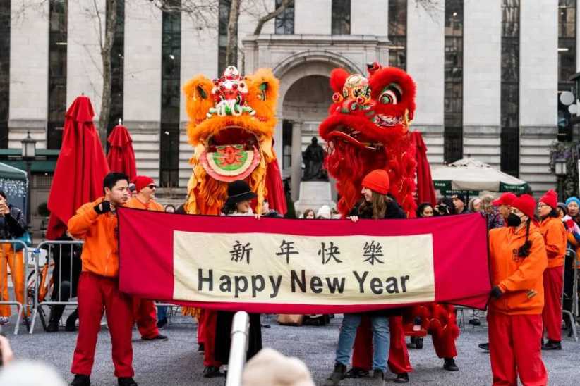 Lions dancers holding a happy new year sign.
