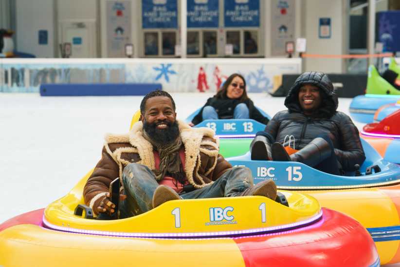 Kids and adult laughing and having fun on the bumper cars on ice at Bryant Park