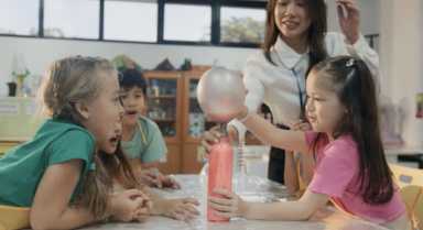 Kids playing with science with camp teacher