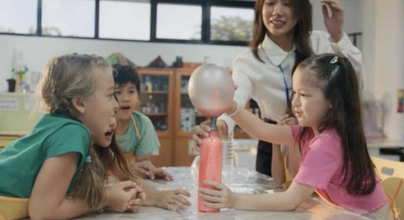 Kids playing with science with camp teacher
