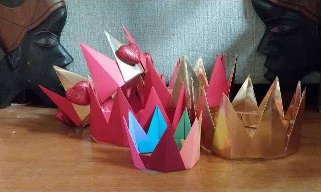 Multiple hand made crowns on a table. 