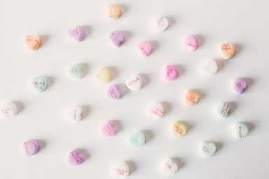 Candy message hearts laid out on a flat surface.