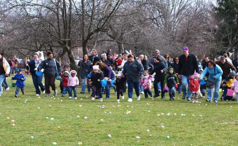 Families getting ready for an Easter Egg hunt on a lawn