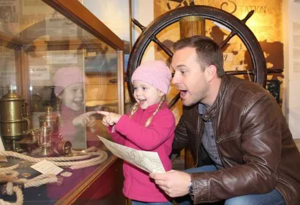 Father and young daughter looking at clues on a map.