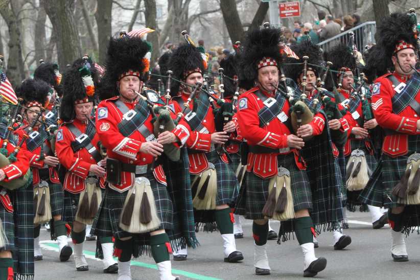Bagpipers marching in a parade.