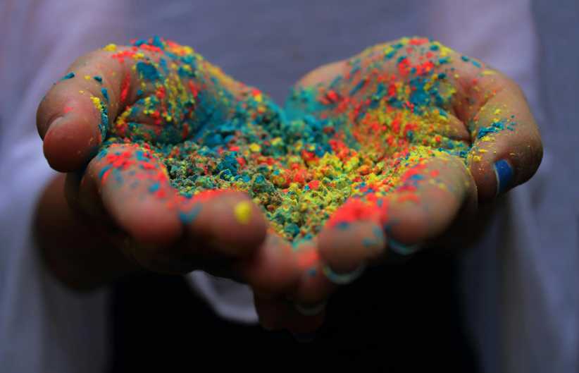 Hands covered in color powder