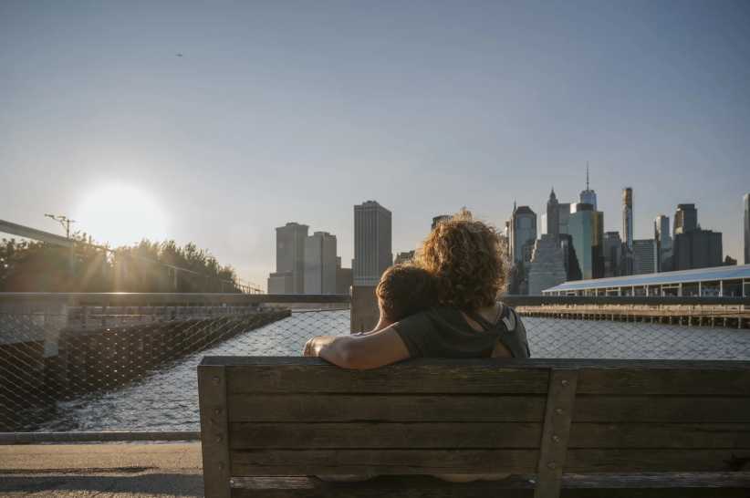 Mother and Child Sharing a Moment Overlooking NYC Skyline at Sunset, 21 Free and Fun Spring Break Activities for Kids in New York City