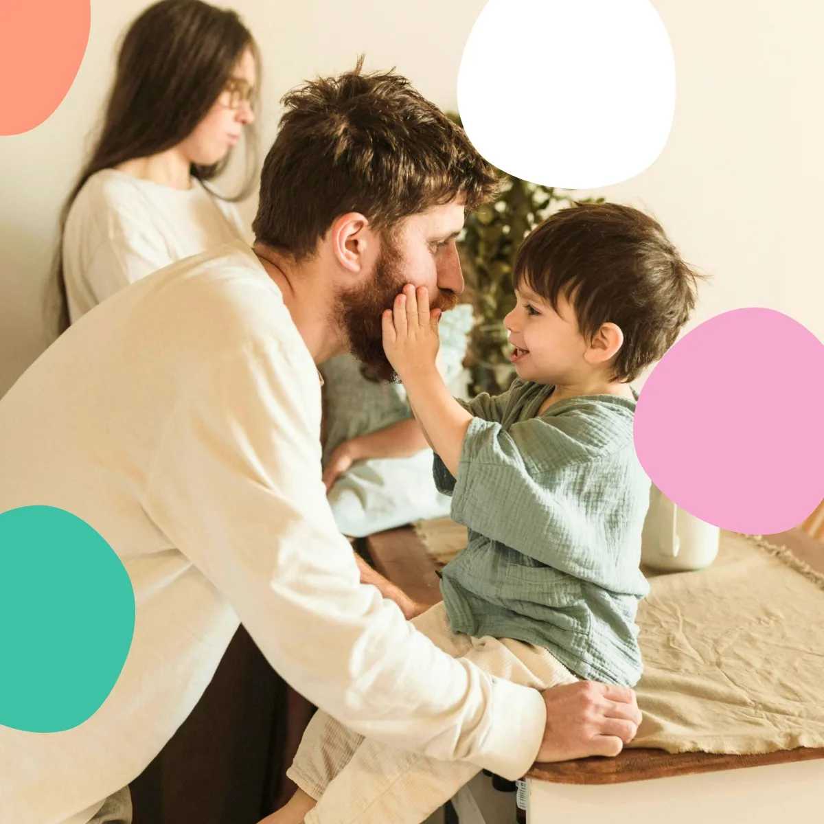 A young child looking up at his father, touching his face