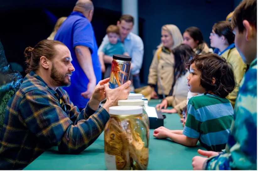 American Museum of Natural History scientist talking to child at EarthFest at AMNH: Fun Family Events to Celebrate Earth Day