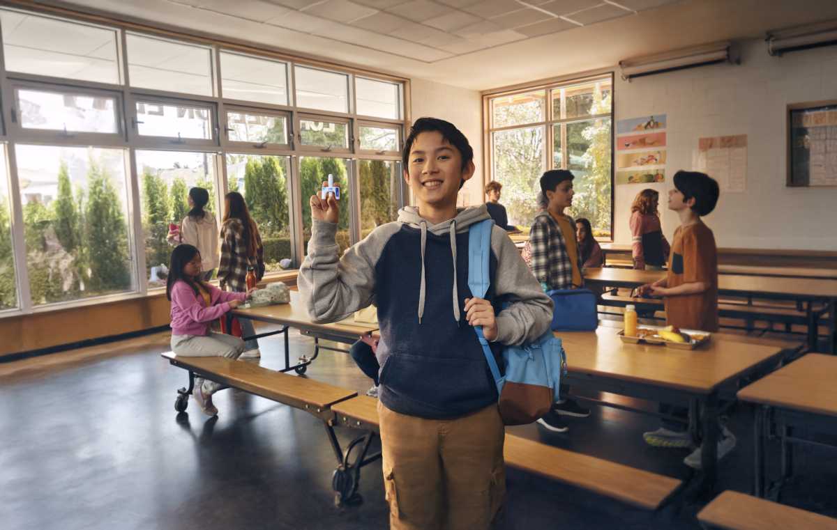 neffy being held by child in classroom
