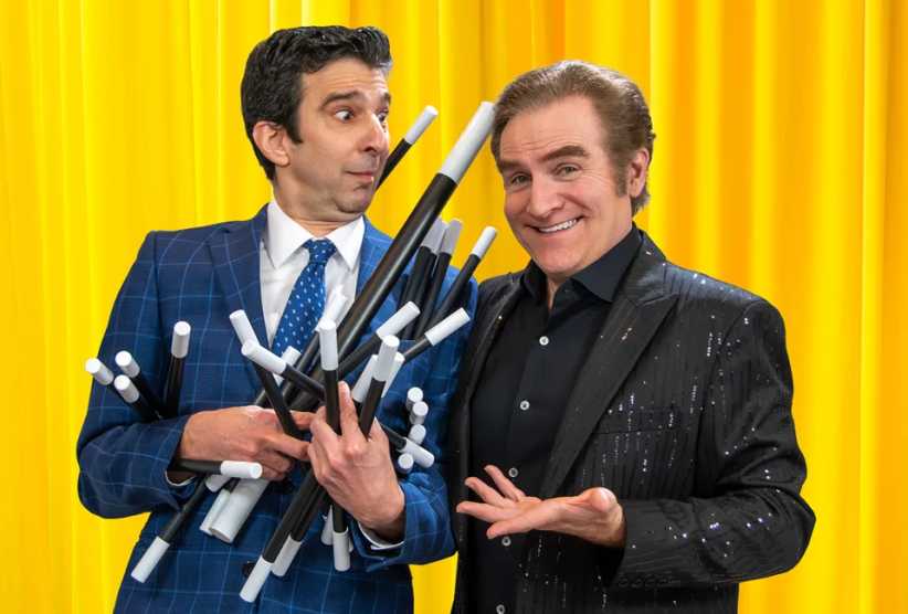 Jim Vines and Carl Mercurio performing on stage.