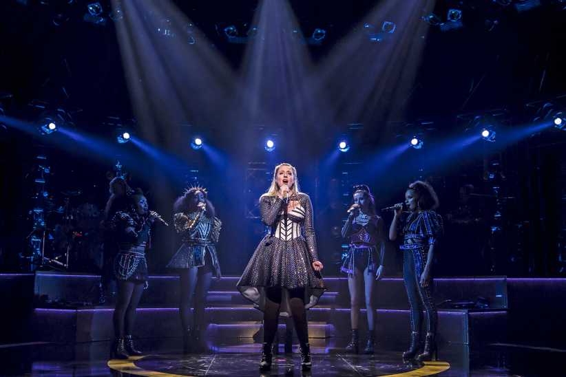 Young blonde woman singing on Broadway Week stage